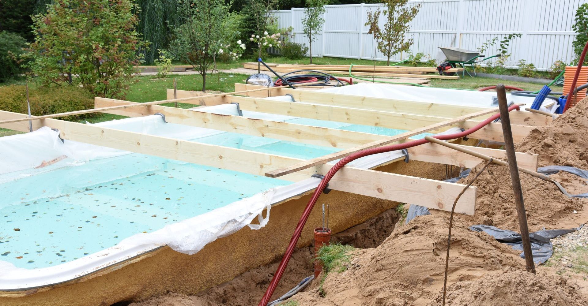 Beautiful residential swimming pool surrounded by a finished patio and landscaped outdoor space